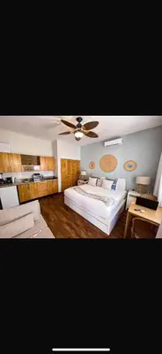 a bedroom with a bed and a ceiling fan at Loft short walk to the beach and restaurant in La Fragata