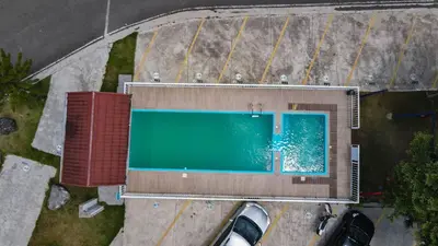 an overhead view of a building with a swimming pool at Charming Apartment in Jarabacoa with Shared Pool in Jarabacoa