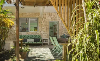 a patio with a couch and a table and chairs at Lux Garden Loft close to Beach, Kite-school in Cabarete