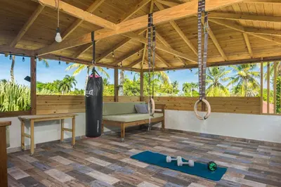 a pavilion with a gym with a bench and a swing at Lux Garden Loft close to Beach, Kite-school in Cabarete
