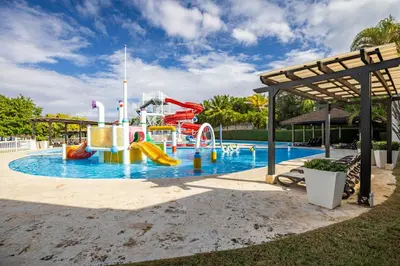 a pool with a water park with a slide at Sosua Ocean Village Villa 24 in Sosúa