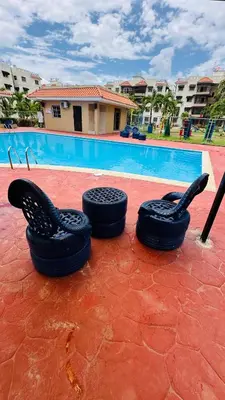 two tires sitting next to a swimming pool at green oasis vacation retreat in La Grúa