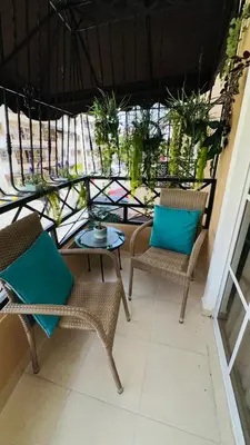 a patio with chairs and a table and a window at green oasis vacation retreat in La Grúa