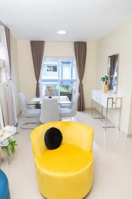 a living room with a yellow couch and a table at La Isla Royal - Marea Estelar in Miches