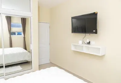a bedroom with a mirror and a tv on a wall at La Isla Royal - Marea Estelar in Miches