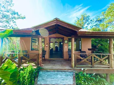 a home with a wooden porch with a porch at Luxury Villa Heated Pool, Firepit & Pool Table in Arroyo Frío