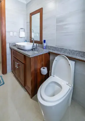 a bathroom with a white toilet and a sink at Stylish Punta Cana Apartment - Eden Caribe in Punta Cana