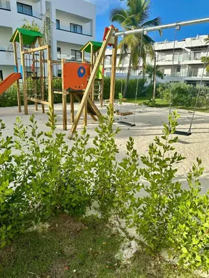 a playground with a swing set on a beach at Swim-Up Paradise, AirBB for more info in Punta Cana
