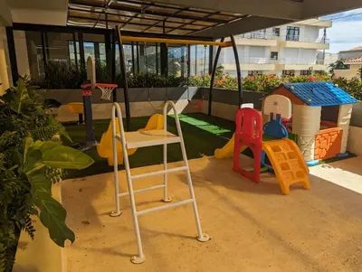 a playground with a chair and a play set at Apt in luxurious condominium near the beach in Juan Dolio