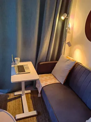 a room with a table and a laptop on a couch at Apt in luxurious condominium near the beach in Juan Dolio