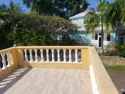 a yellow fence in front of a house at 4 bedroom villa, private pool, ocean view, security in Sosúa