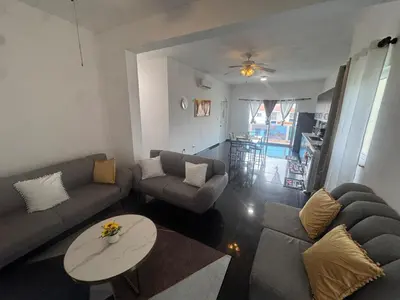a living room with two couches and a table at Modern 3-Bedroom Apartment with Pool in Boca Chica