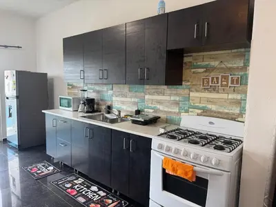 a kitchen with a white stove and a refrigerator at Modern 3-Bedroom Apartment with Pool in Boca Chica