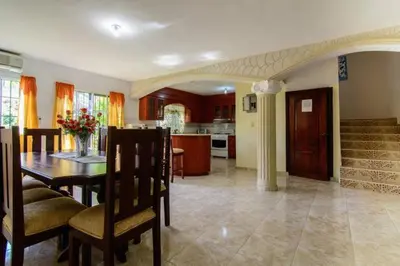 a dining room and kitchen with a table and chairs at The Three Sisters Villa in Puerto Plata