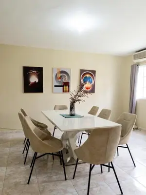 a dining room with a white table and chairs at 3BR Villa Newly Renovated-5 min to Playa Dorada H1 in Puerto Plata