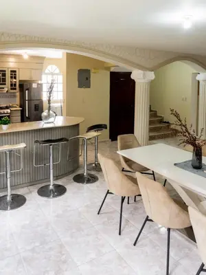 a kitchen and dining room with a table and chairs at 3BR Villa Newly Renovated-5 min to Playa Dorada H1 in Puerto Plata