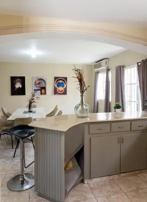 a kitchen with a large island with a table at 3BR Villa Newly Renovated-5 min to Playa Dorada H1 in Puerto Plata