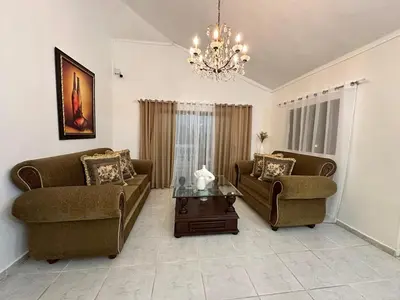 a living room with two couches and a coffee table at Entire House in Santo Domingo Este in Los Frailes