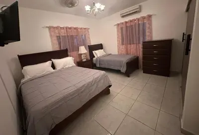 a bedroom with two beds and a dresser at Entire House in Santo Domingo Este in Los Frailes