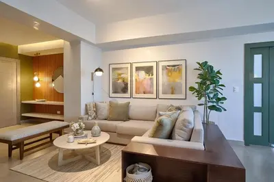 a living room with a couch and a table at ®{PANO~VIEW~Experience} @DowntownSD PoolGym2BR in Santo Domingo