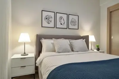 a bedroom with a bed with four pictures on the wall at ®{PANO~VIEW~Experience} @DowntownSD PoolGym2BR in Santo Domingo