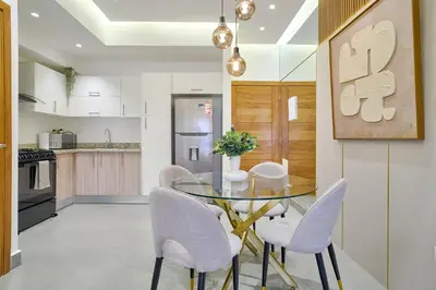 a kitchen and dining room with a glass table and chairs at ®{Designer~City~Stay} @DowntownSD NearPark1BR in Santo Domingo