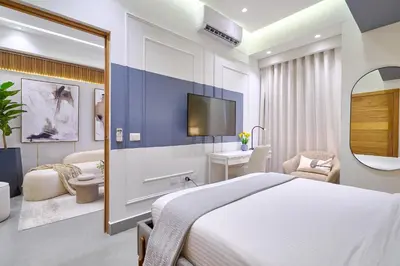 a hotel room with a bed and a tv at ®{Designer~City~Stay} @DowntownSD NearPark1BR in Santo Domingo