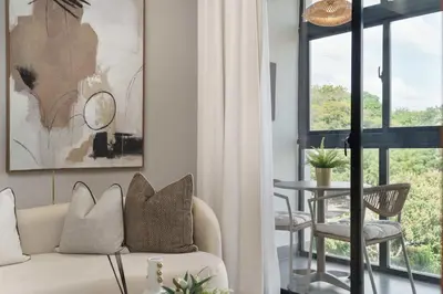 a living room with a couch and a table at ®{Designer~City~Stay} @DowntownSD NearPark1BR in Santo Domingo