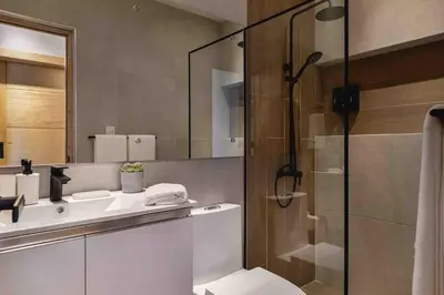 a bathroom with a shower and a toilet and a sink at ®{LUX~City~Skyline} @DowntownSD PrivéJaccuziGym in Santo Domingo