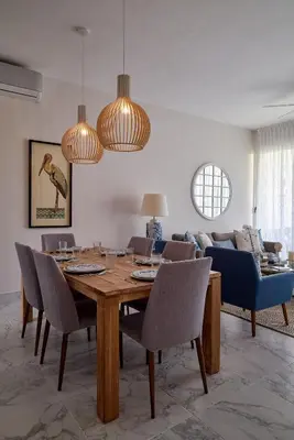 a dining room with a table and a couch at {3BR~Beach~Condo}@LakeView PlayaBonita PoolLUX in Las Terrenas