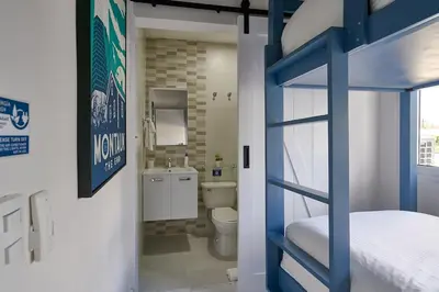 a bedroom with a bunk bed and a bathroom at {3BR~Beach~Condo}@LakeView PlayaBonita PoolLUX in Las Terrenas