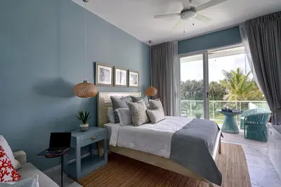 a blue bedroom with a bed and a window at {3BR~Beach~Condo}@LakeView PlayaBonita PoolLUX in Las Terrenas