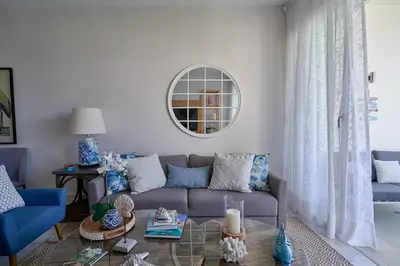 a living room with a couch and a table at {3BR~Beach~Condo}@LakeView PlayaBonita PoolLUX in Las Terrenas
