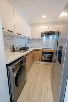 a kitchen with a washer and a dishwasher at Suite Boho Swim-Up | Acceso Directo. Playa Privada in Punta Cana