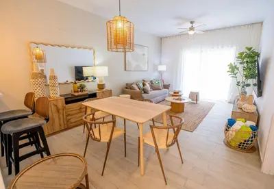 a living room with a table and chairs at Suite Boho Swim-Up | Acceso Directo. Playa Privada in Punta Cana
