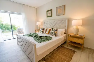 a bedroom with a bed with a wooden headboard at Suite Boho Swim-Up | Acceso Directo. Playa Privada in Punta Cana