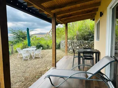 a chair on a porch with a table and chairs at Villa ana in Colorado