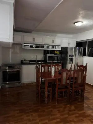 a kitchen with a table and chairs in a room at Wooden Paradise in Jarabacoa in Jarabacoa