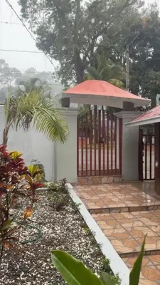 a house with a gate and a courtyard at Wooden Paradise in Jarabacoa in Jarabacoa