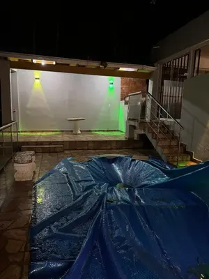 a stage with a blue tarp on the floor and a staircase at Wooden Paradise in Jarabacoa in Jarabacoa