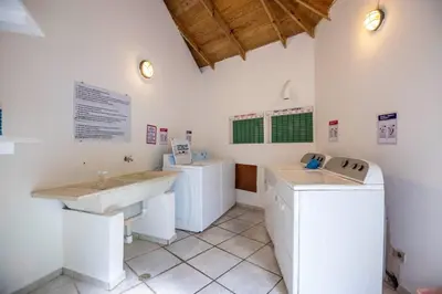 a laundry room with two washes and a washer and dryer at Renaissance Residence Cabarete in Cabarete