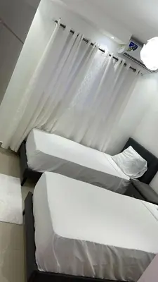 a room with two beds and a window at Colinas del arroyo in Santo Domingo