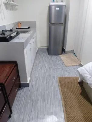 a kitchen with a stainless steel refrigerator in a room at Habitacion cerca de la Playa in Boca Chica