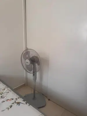 a small fan in a corner of a room at quality & comfort in Santo Domingo