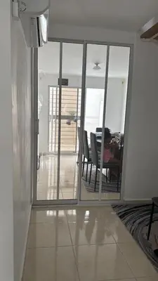 a dining room with sliding glass doors and a table at quality & comfort in Santo Domingo