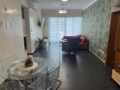 a living room with a glass table and a couch at Dreamvillage in Boca Chica