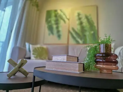 a living room with a table with books and a cross at Garden Breeze Penthouse & Pool View l Ghibli 401 in La Laguna