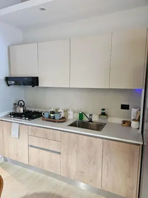 a kitchen with white cabinets and a sink at Garden Breeze Penthouse & Pool View l Ghibli 401 in La Laguna