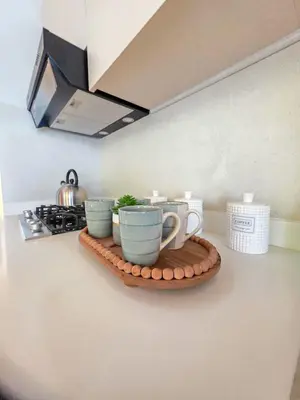 a tray with three cups on a counter in a kitchen at Garden Breeze Penthouse & Pool View l Ghibli 401 in La Laguna