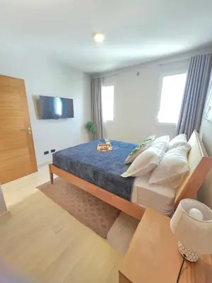 a bedroom with a large bed with blue sheets and pillows at Caribbean Comfort near the Sea l Cefiro 101 in La Laguna
